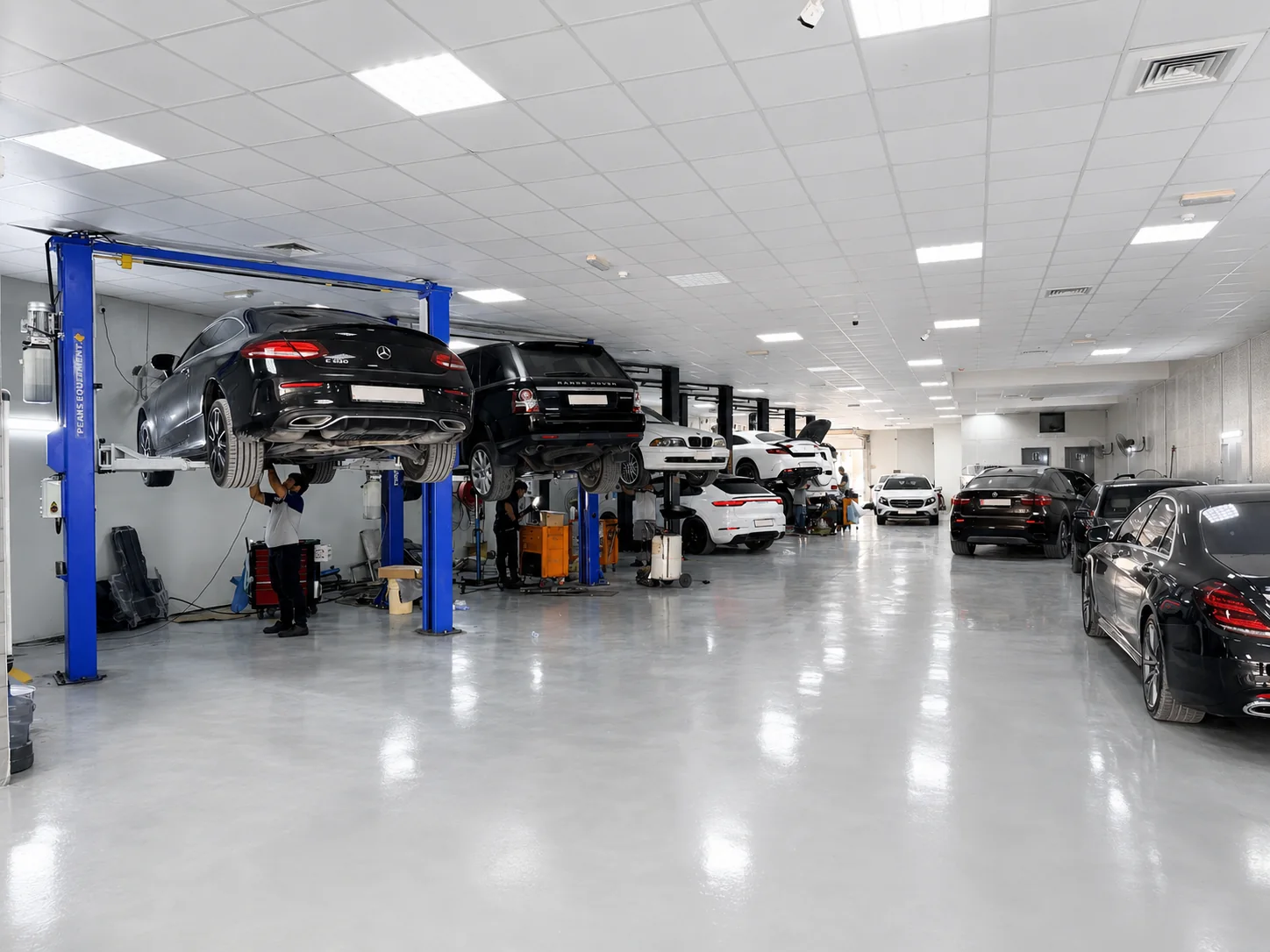 John Auto service bay with vehicles being maintained on workshop lifts